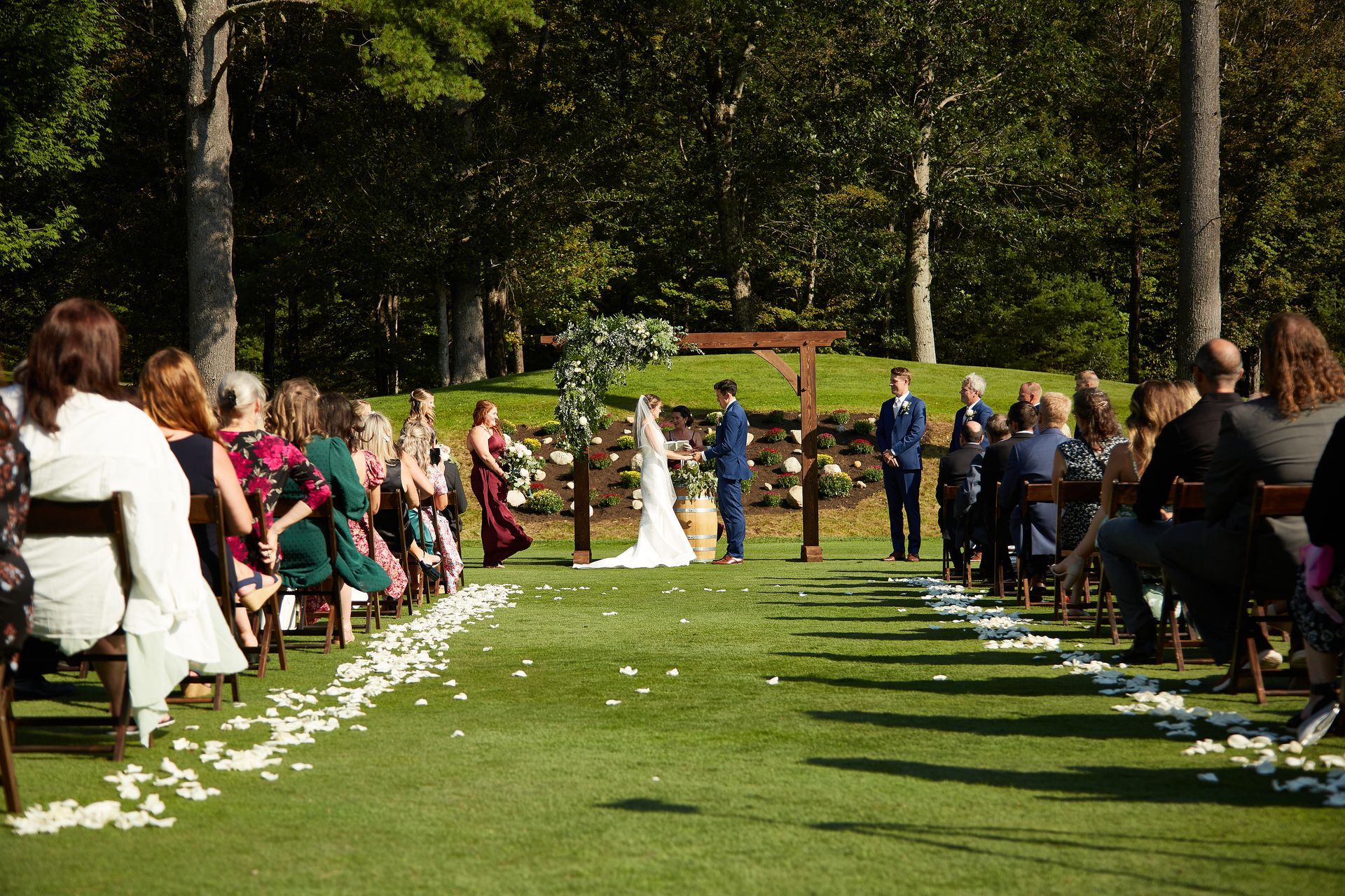 A group of people are sitting in chairs at a wedding ceremony.