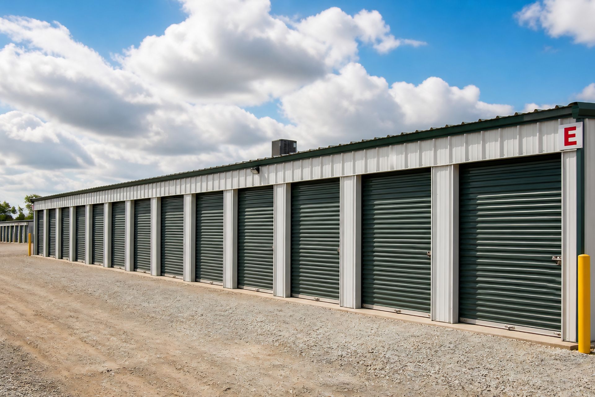 A blue metal storage building with a banner that reads