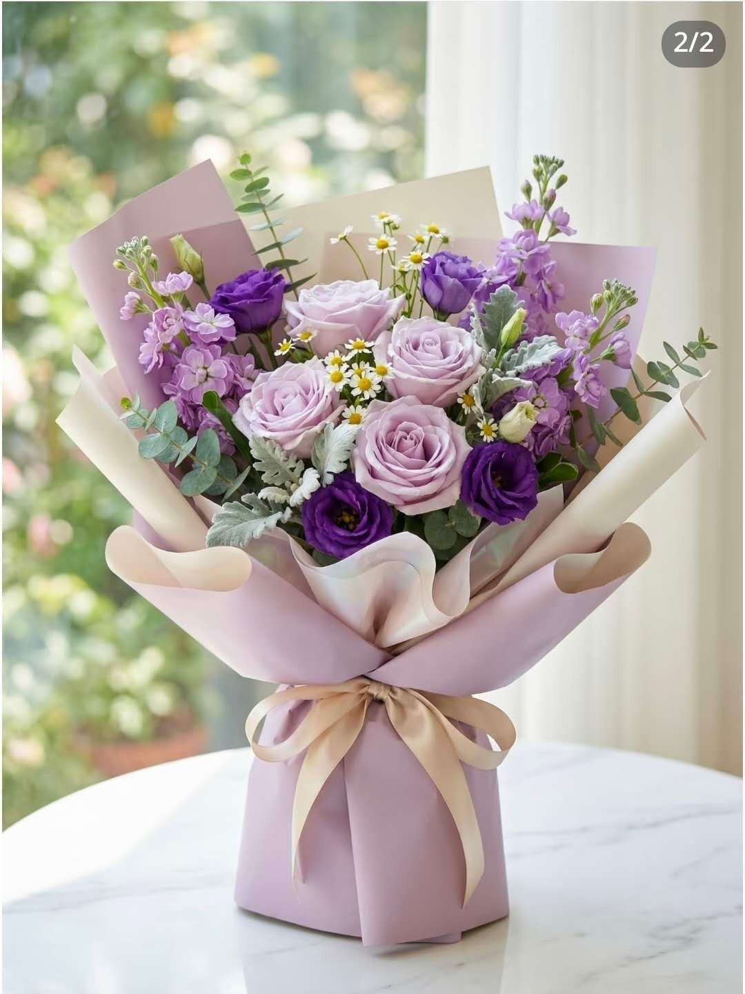 Lavender rose bouquet in pastel wrapping with ribbon, arranged on a table by a window.