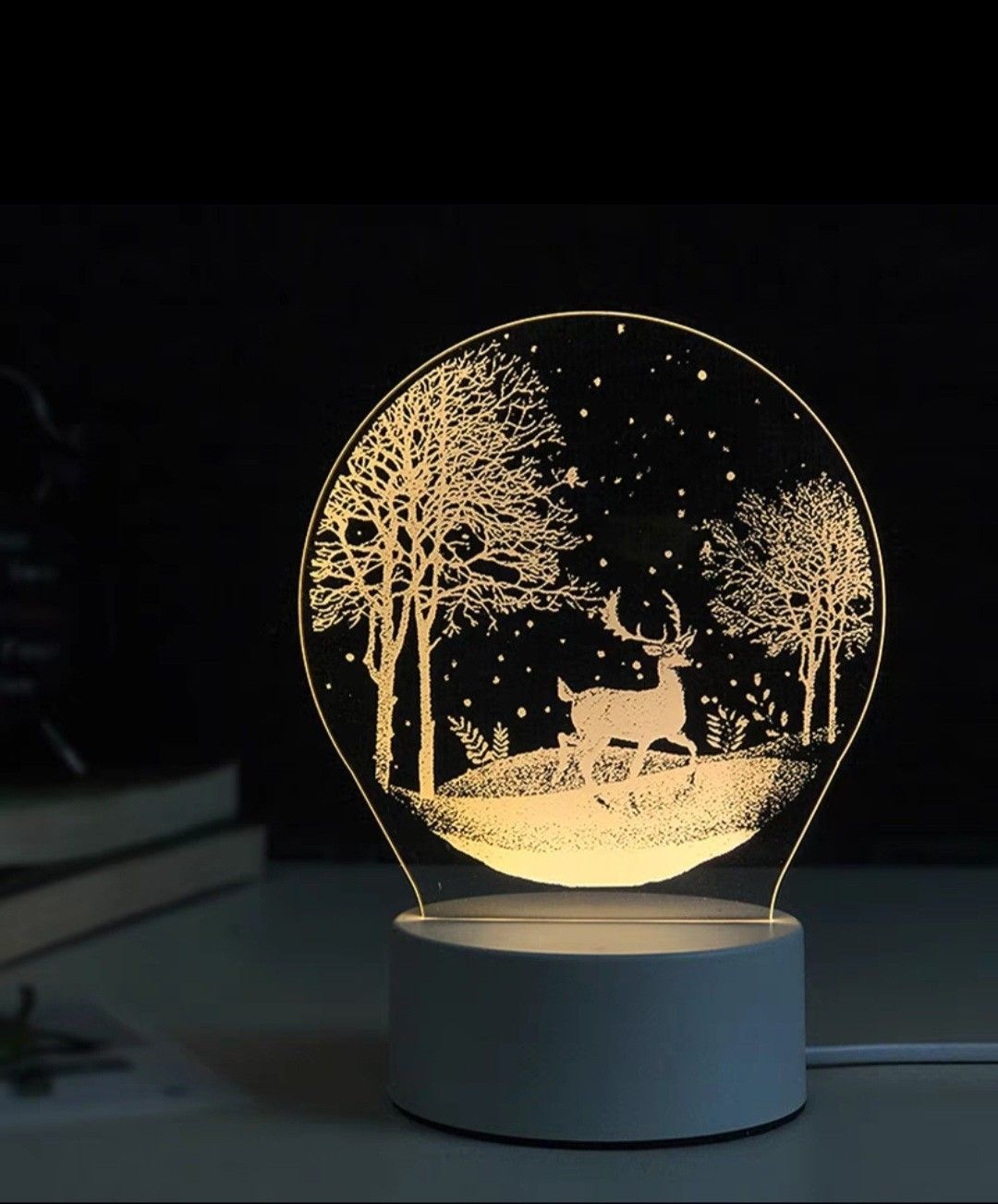 Glowing circular LED lamp with a deer and trees silhouette on a white base