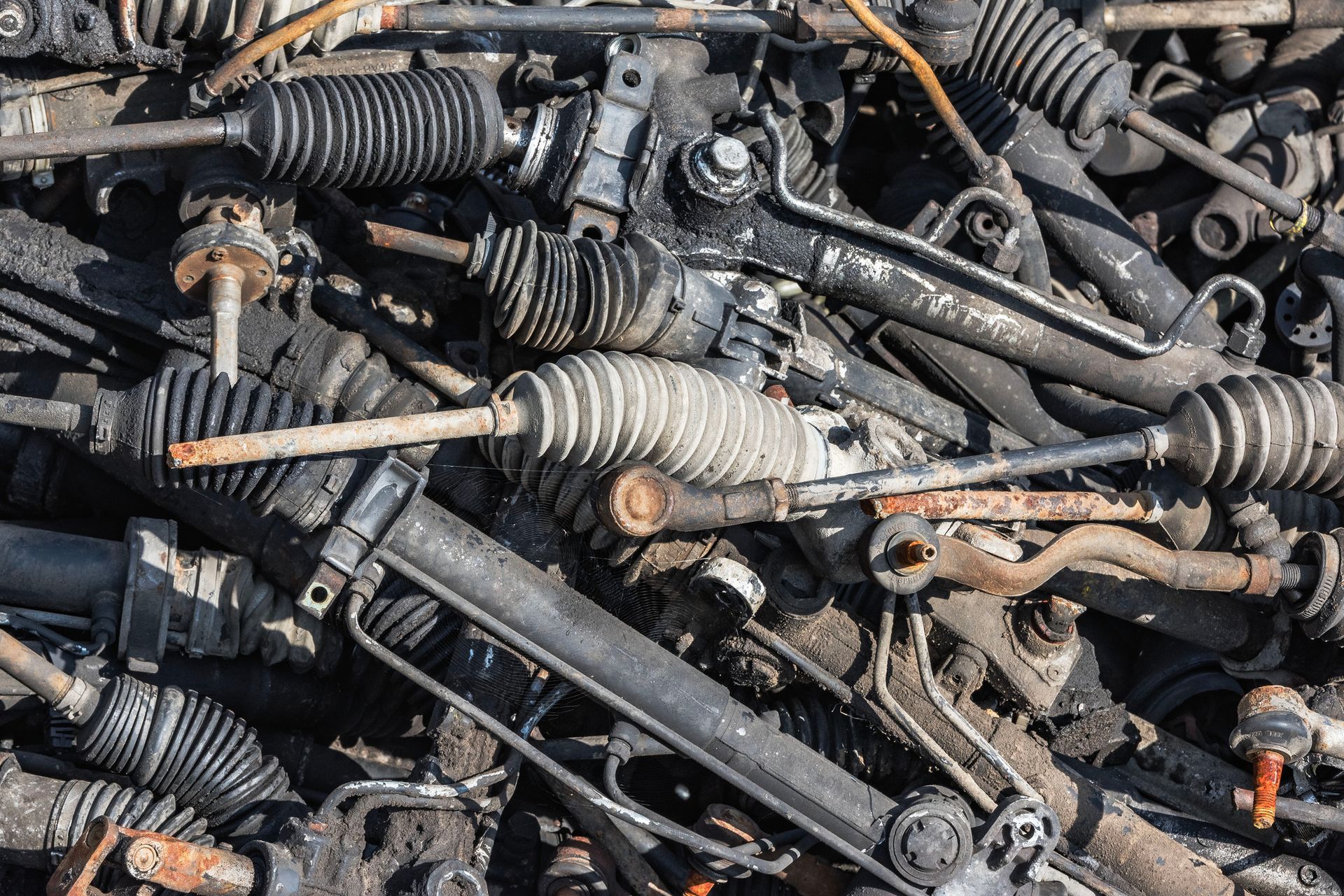 Stacked used auto parts including engines and transmissions in a salvage yard. Stacked used auto parts including engines and transmissions in a salvage yard.