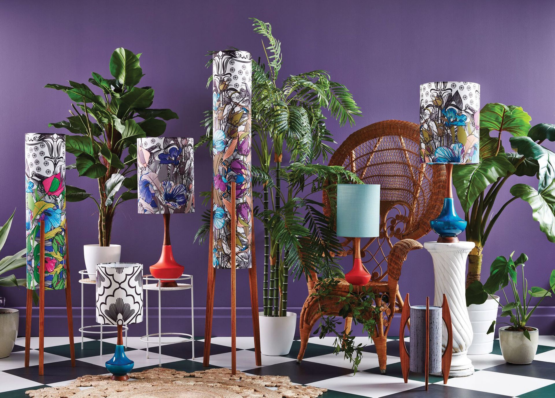 Decorative indoor scene with colorful patterned planters, plants, and woven chairs against a purple wall