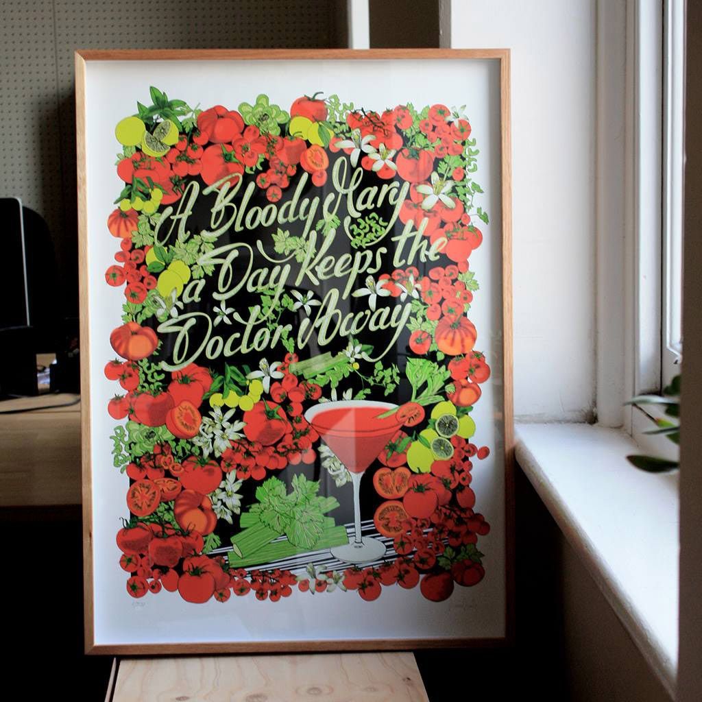 Framed floral poster with a cocktail glass and stylized text on a windowsill