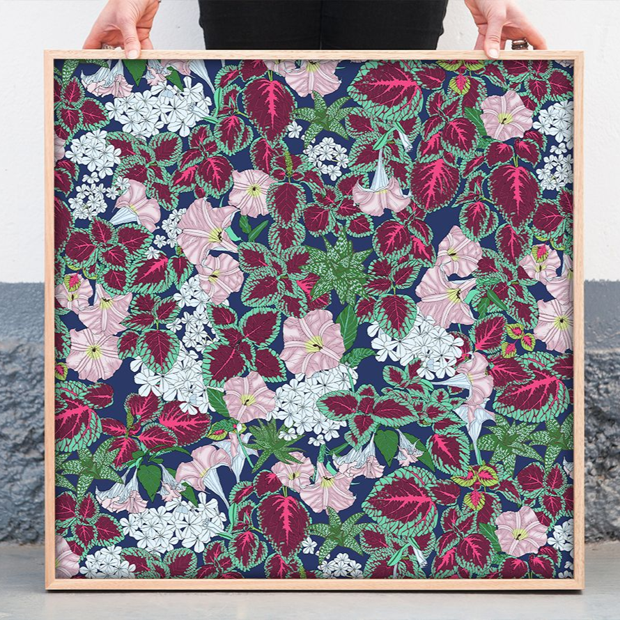 Framed floral collage with dense pink, green, white, and navy blossoms on a patterned background