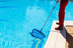 pool cleaning contractor filtering dirt from pool