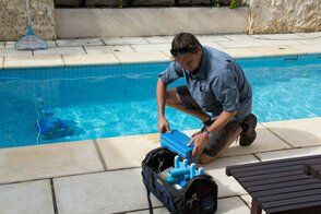 pool cleaning contractor unpacking his cleaning materials