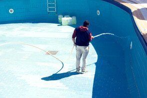 pool cleaning contractor clearing out debris from the pool