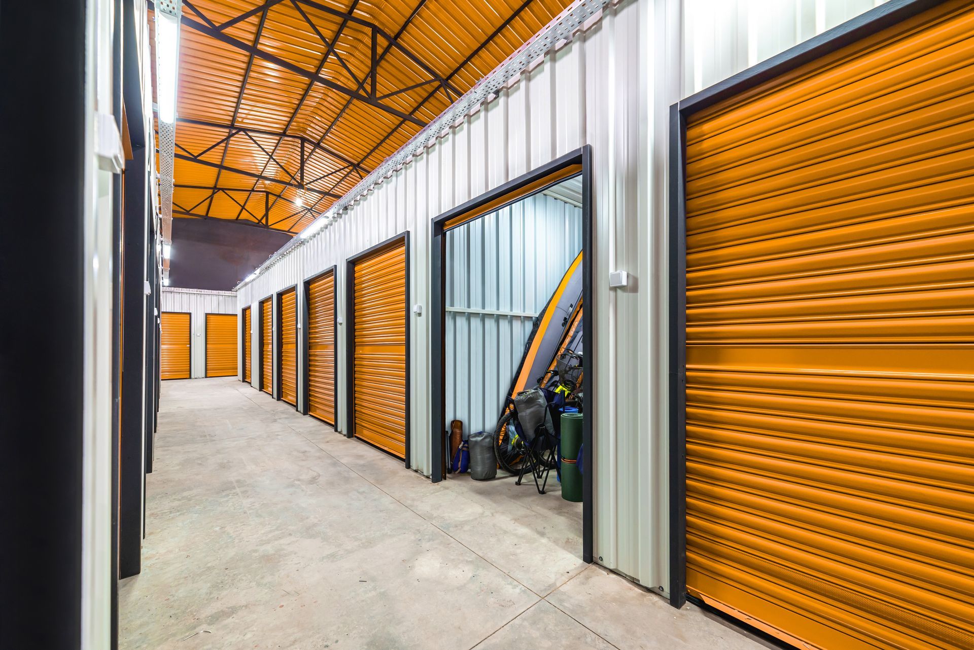 Corridor of self-storage unit with yellow doors.