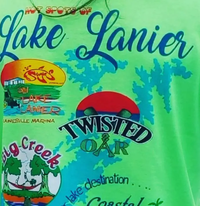 Green T-shirt graphic with “Lake Lanier,” “Twisted Oar,” and other colorful lake-themed logos.