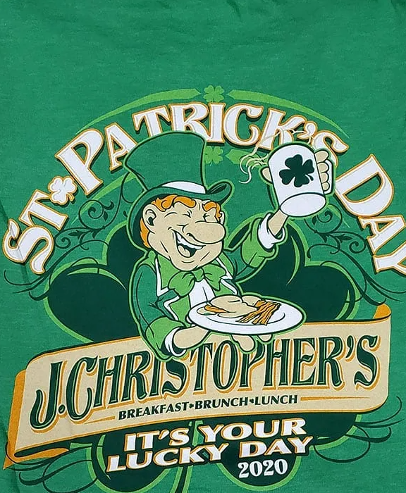 St. Patrick’s Day sign for J. Christopher’s with a smiling leprechaun holding a beer mug and shamrock plaque