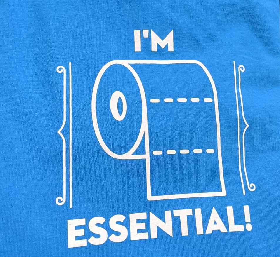 Blue shirt graphic with a toilet paper roll and the words “I’M ESSENTIAL!”