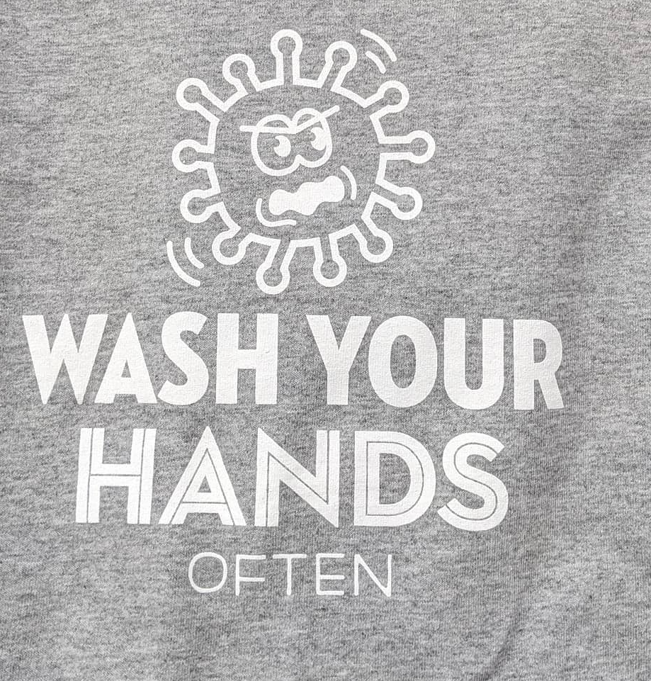 Gray shirt with cartoon germ and the text “WASH YOUR HANDS OFTEN”