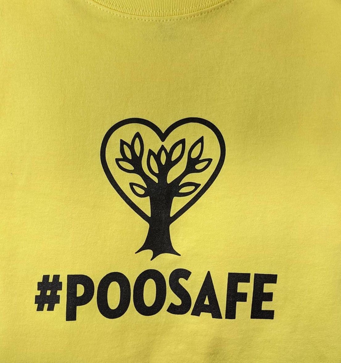 Yellow shirt with black tree-heart logo and the text “#POOSAFE”