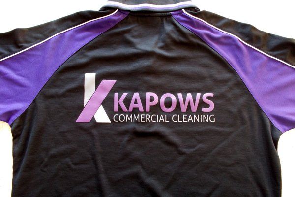Black and purple Kapows Commercial Cleaning shirt with logo on the back