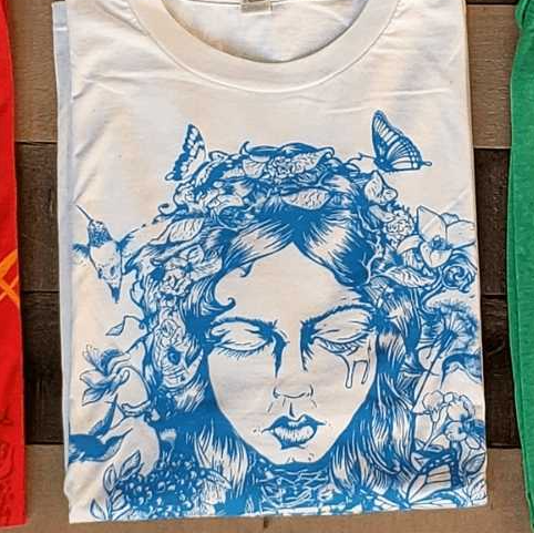 White T-shirt with blue floral woman's face graphic and butterflies