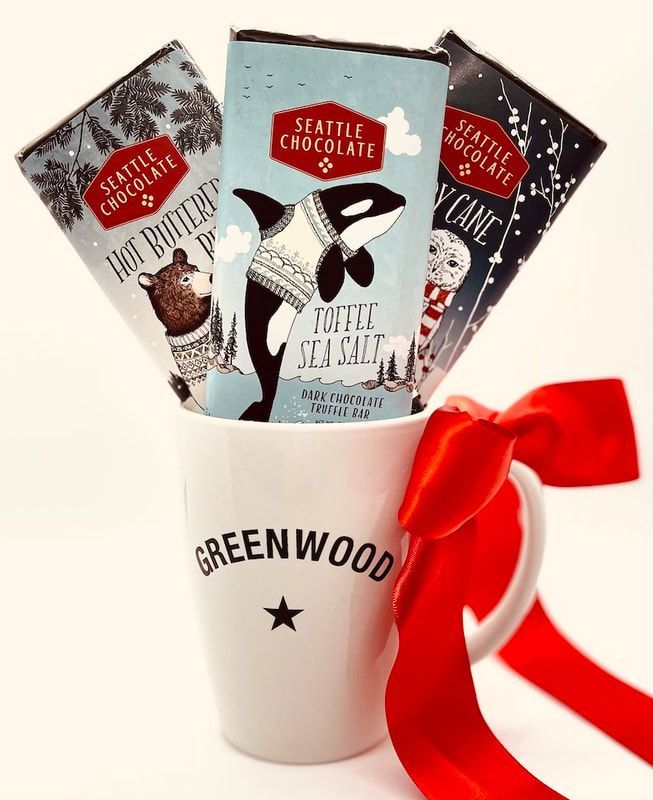 White mug labeled GREENWOOD holding three Seattle Chocolate bars with a red ribbon bow.