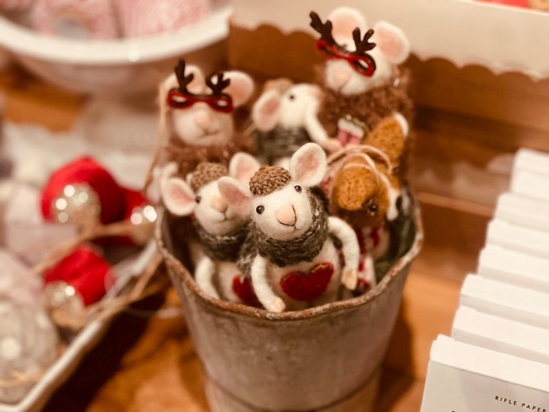 Mini plush mice in a small cup with red hearts, arranged on a festive dessert table