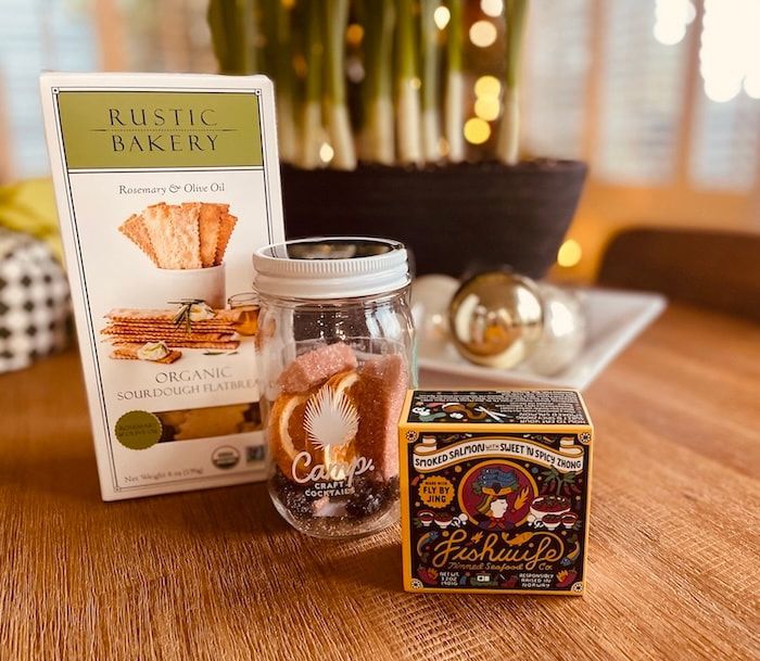 Rustic Bakery crackers and a jar on a wooden table with a decorative candle box in warm light