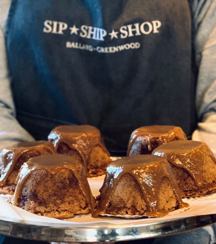 Chocolate-covered dessert squares on a plate, with a person in a Sip + Ship + Shop apron behind them