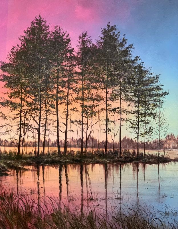 Tall pine trees reflected in calm water under a pink and blue dawn sky