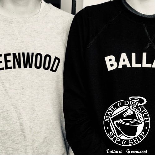 Two people in matching black and white shirts with text and a circular logo reading “Bali & Greenwood.”