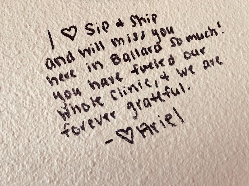 Handwritten note on paper expressing missing someone and saying “I ❤️ Sis + Shi” signed “Ariel”