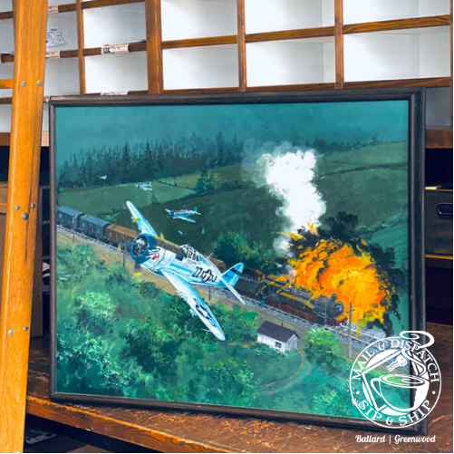 Framed painting of a blue airplane flying over a burning train track in a green landscape