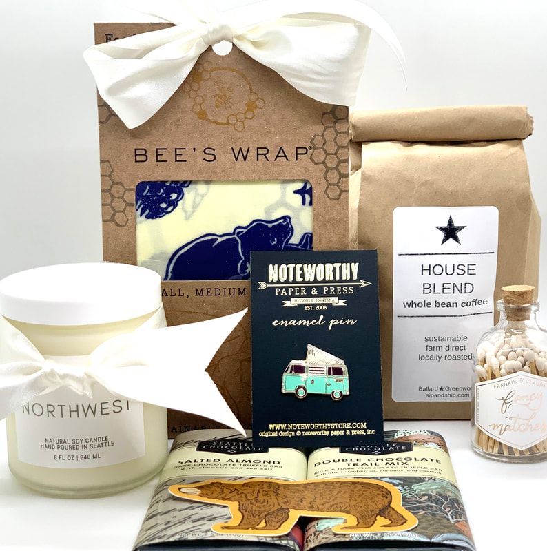 Assorted natural products in kraft packaging, including soap, candles, tea, and beeswax wrap.