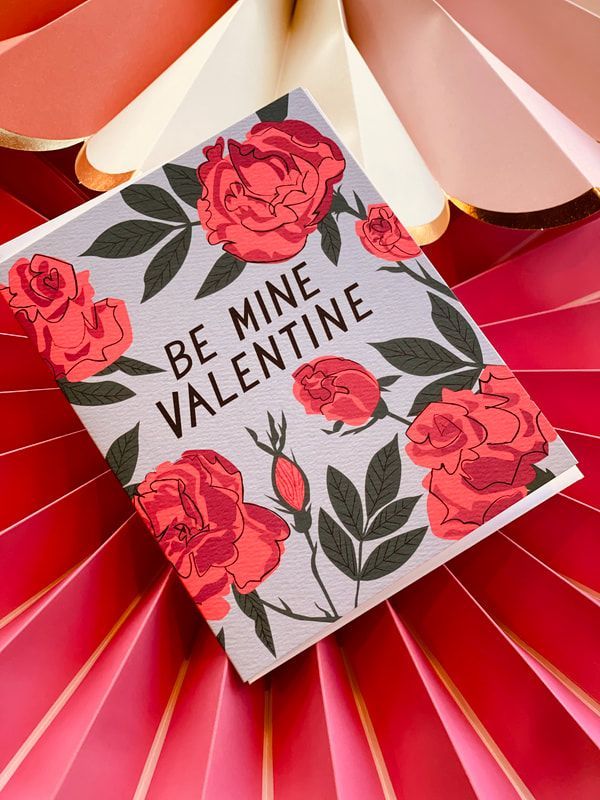 Valentine card with red roses and the words “BE MINE VALENTINE” on a pink and red background