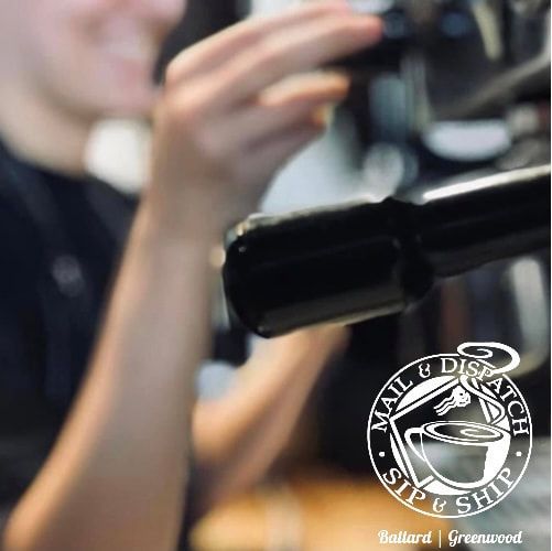 Blurred person holding a black microphone or camera in a warm indoor setting.