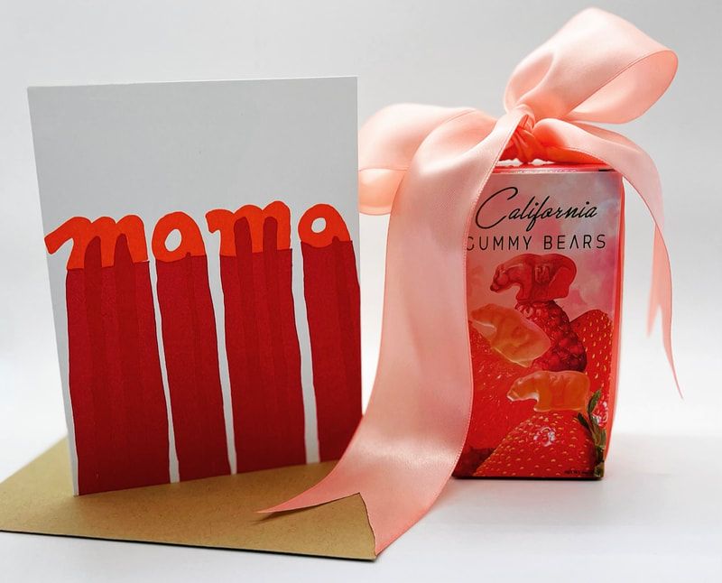 Red-and-white greeting card beside a pink ribbon gift bag of California gummy bears on a kraft paper base