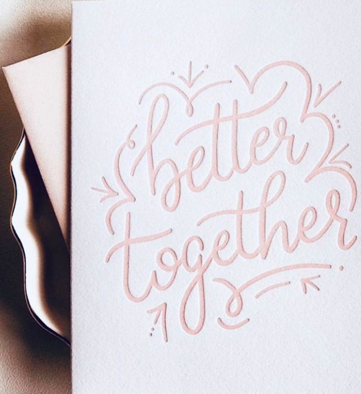 Handwritten pink “Better Together” on white paper with small hearts and flourishes