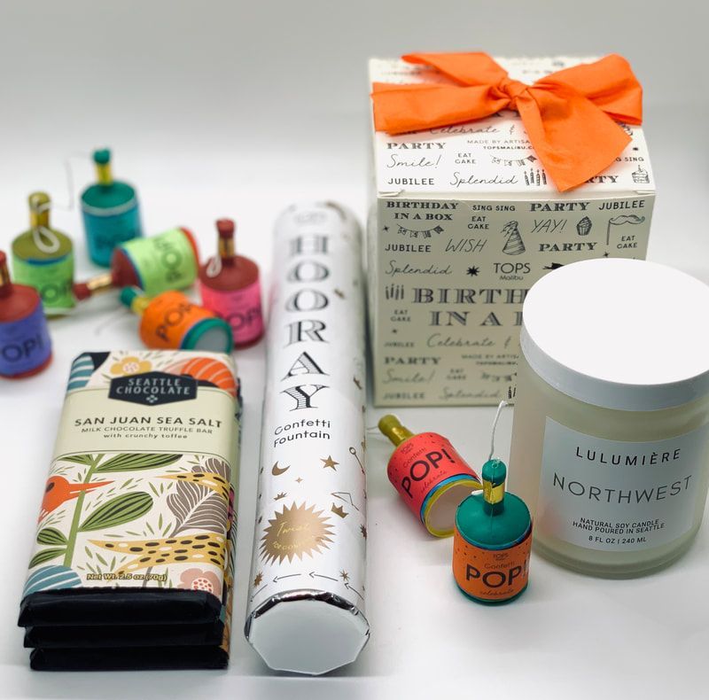 Spa gift set with candles, bath products, and boxed presents tied with an orange ribbon