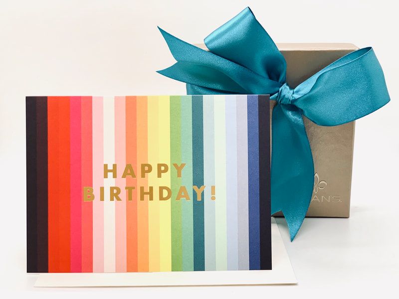Happy Birthday card with rainbow stripes and a teal ribbon on a gift box