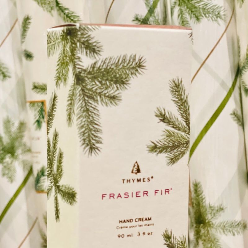 Thymes Frasier Fir hand cream tube with pine branch design on a light background