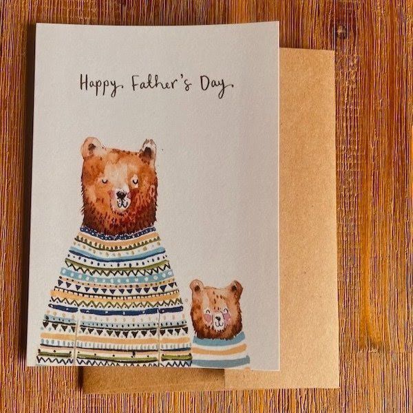 Father’s Day card with two illustrated bears in patterned sweaters on a white and tan background
