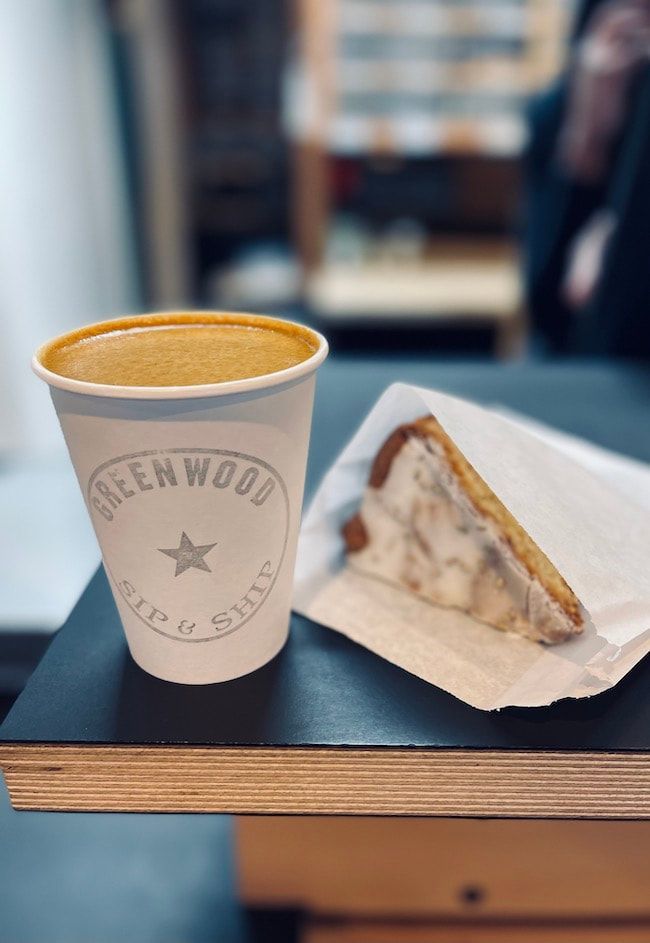 Coffee cup and a slice of pie on a tray at a café table