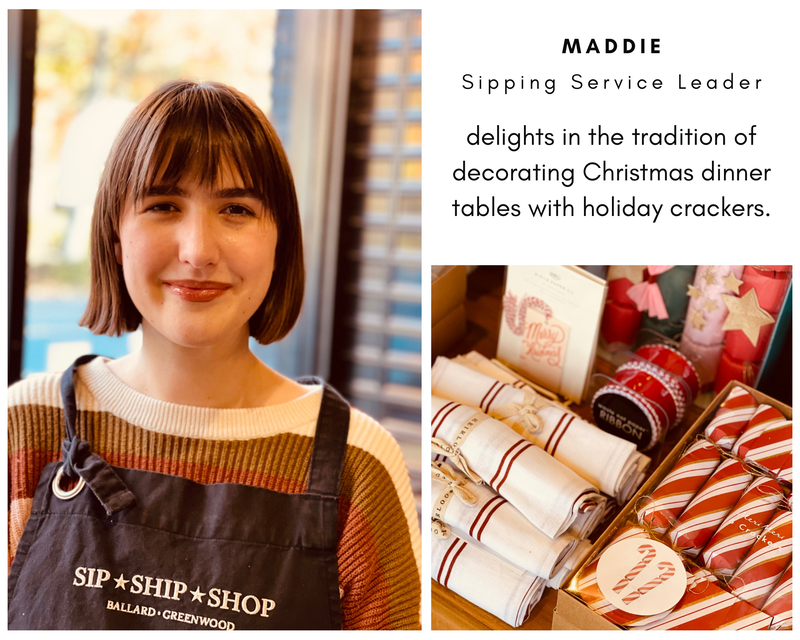 Shop employee beside holiday crackers and table settings in a Sip Shop Shop display