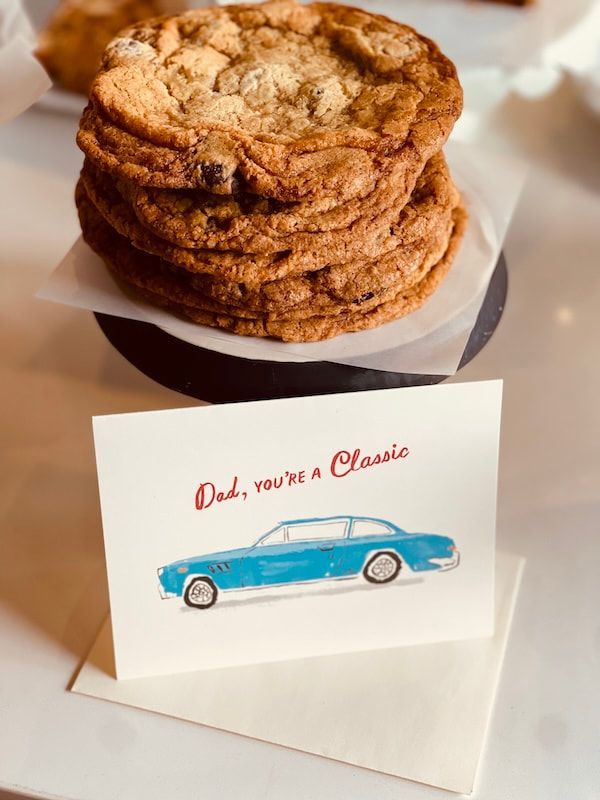 Stacked cookies on a white box with a card reading “Dad, you’re a Classic” and a blue vintage car illustration
