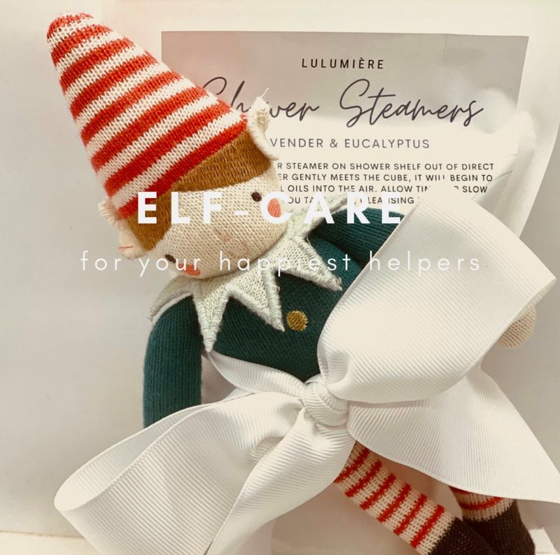 Red-and-white striped elf shoes with a white bow, displayed against a holiday gift package.