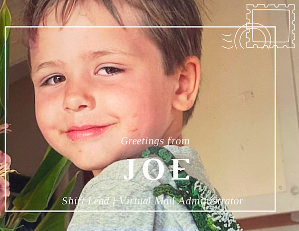 Young child smiling in a decorative greeting card that says “Greetings from Joe”
