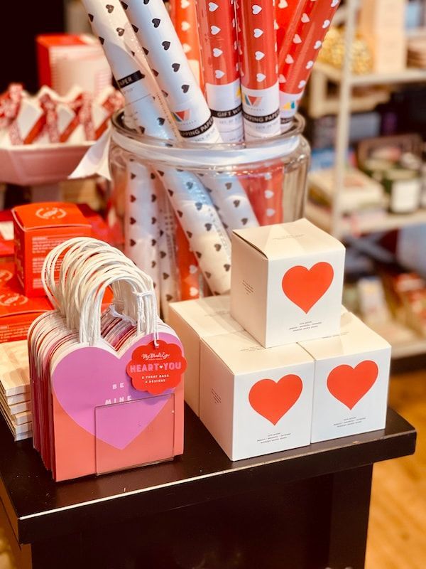 Assorted Valentine’s Day gift boxes and heart-themed stationery on a store display table