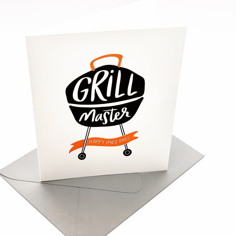Folded greeting card with a black kettle grill logo and orange “Grill Master” ribbon on a gray envelope