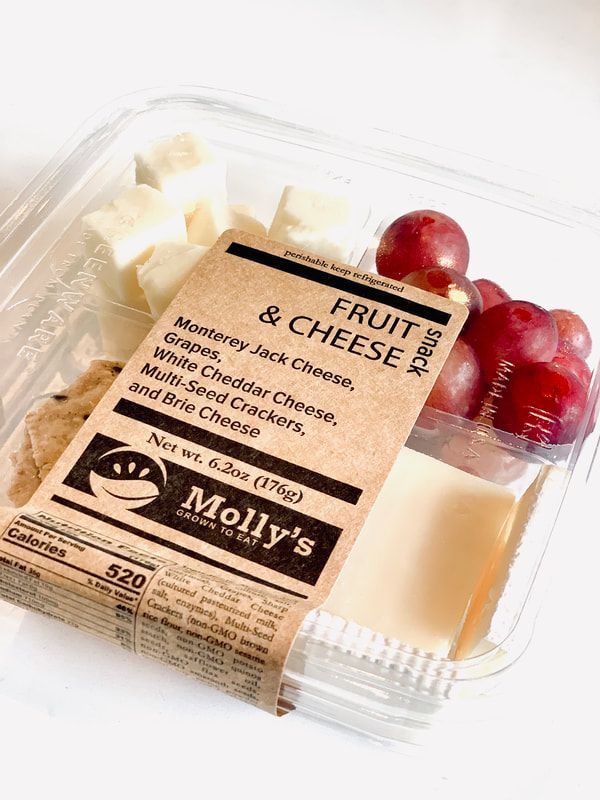 Fruit and cheese snack tray with crackers, grapes, and sliced cheese in a clear container