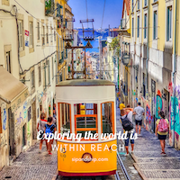 Red tram on a steep Lisbon street with pedestrians and colorful buildings