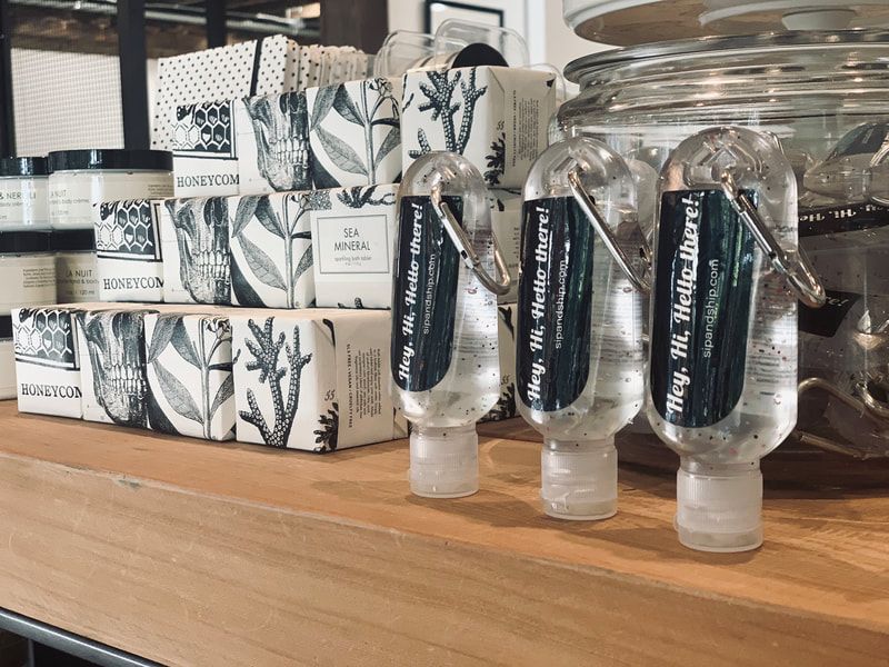 Skincare products displayed on a wooden shelf, including boxed items, jars, and bottles with plant-pattern labels.