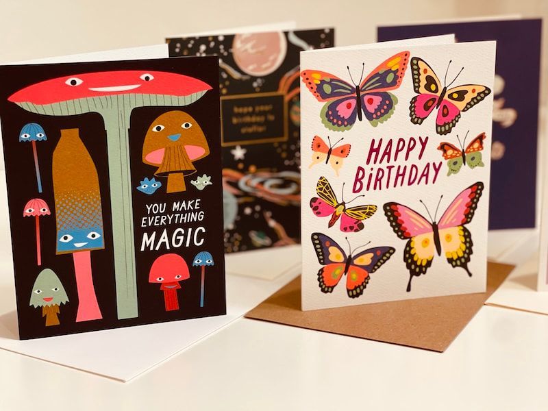 Two handmade birthday cards: one with mushrooms, one with colorful butterflies and “Happy Birthday” text