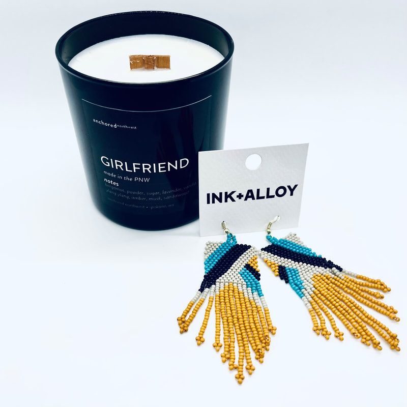 Black candle in a tin with 