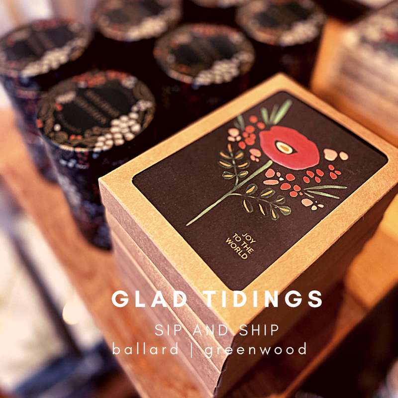 Gift box labeled “Glad Tidings” with black-and-gold sip and ship ballard warewood design