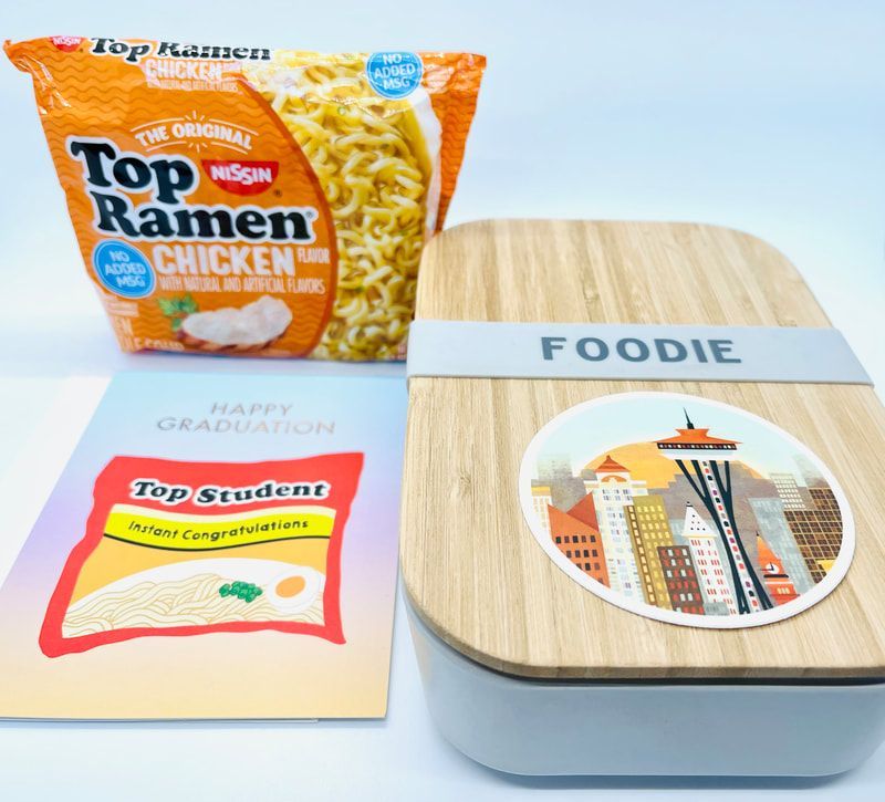 Foodie gift box with Top Ramen, a Top Ramen card, and a wooden tray on a white background